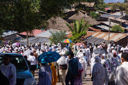 Lalibela, Ethiopia - Nov 2018: Pilgrims dressed in traditional ethiopian white colors gathering outside the Lalibela underground churches.のeditorial素材