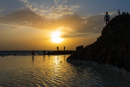 People silhouettes in sunset at Danakil salt lake desert, Ethiopiaの写真素材