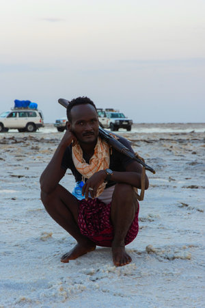Dallol, Ethiopia - Nov 2018: Scout with a rifle posing in Danakil desert, Ethiopia. Scouts are mandatory to accompany tourists in certain areas of the countriesのeditorial素材