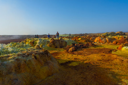 Dallol, Ethiopia - Nov 2018: Tourists passing thru colorful landscape of Dallol terrestrial hydrothermal system in Danakil desert, Ethiopiaのeditorial素材