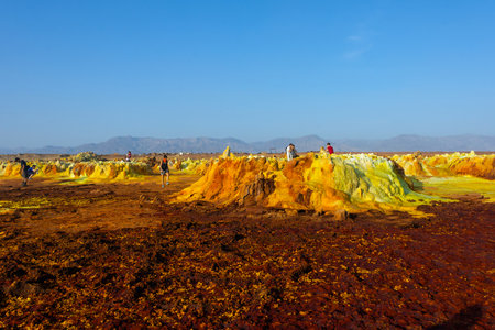 Dallol, Ethiopia - Nov 2018: Tourists passing thru colorful landscape of Dallol terrestrial hydrothermal system in Danakil desert, Ethiopiaのeditorial素材