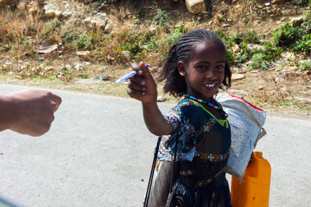 Mekele, Ethiopia - Nov 2018: Handing pencils to school kids in Ethiopiaのeditorial素材