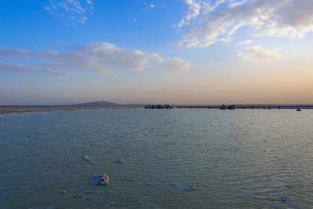 Dallol, Ethiopia - Nov 2018: Driving by 4x4 at scenic Danakil depression salt lake in sunset, with Erta Ale volcano in the background.のeditorial素材