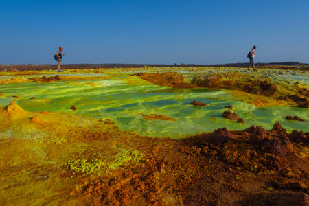 Dallol, Ethiopia - Nov 2018: Tourists walking around color ponds of surreal Dallol desert landscape, Danakil, Ethiopiaのeditorial素材