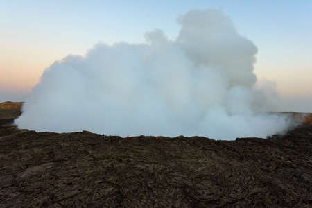 Group of people at the edge of Erta Ale volcanic crater, Ethiopiaの写真素材