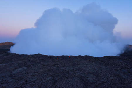 Group of people at the edge of Erta Ale volcanic crater, Ethiopiaの写真素材