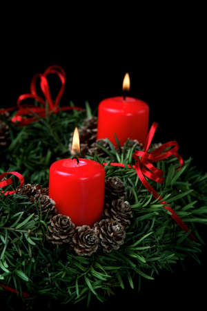 Two red burning candles on advent wreath の写真素材