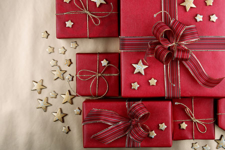 Red Christmas presents on golden surface 
