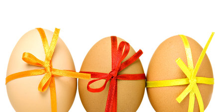 Easter eggs with different ribbons and bows, isolated on white