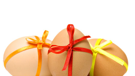 Easter eggs with different ribbons and bows, isolated on white