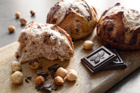 Close-up view of homemade pastry. Broken buns with nuts and chocolate on a cutting board close up...