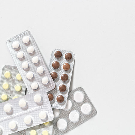 Various medicines: tablets, blister tablets, medications on white background
