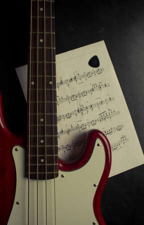 selective focus red bass guitar and notesの写真素材