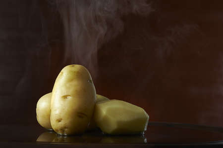 potato isolated on a rustic wooden backgroundの写真素材