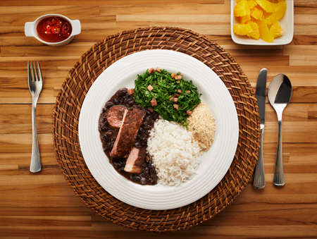 Brazilian feijoada dish on rustic tableの写真素材