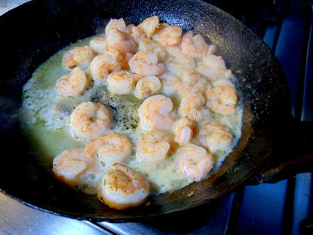 fresh shrimps being cooked in a fryin panの写真素材