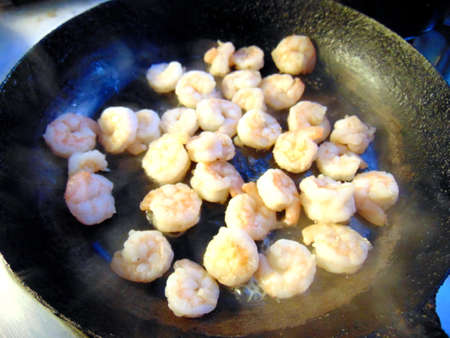 fresh shrimps being cooked in a fryin panの写真素材