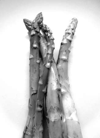 uncooked asparagus in porcelain plateの写真素材