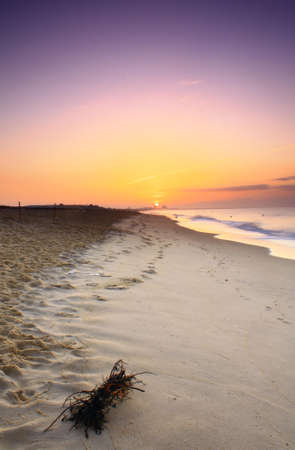 a sunrise on a beautiful beach in the Algarve in Portugal.の写真素材