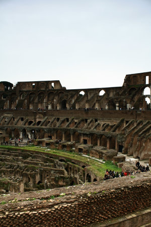 A landscape of the large building in ruins of the Coliseum in Rome.