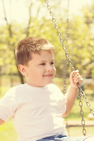 boy swinging in the parkの写真素材