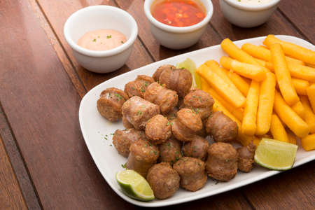 delicious plate of sausage and chipsの写真素材