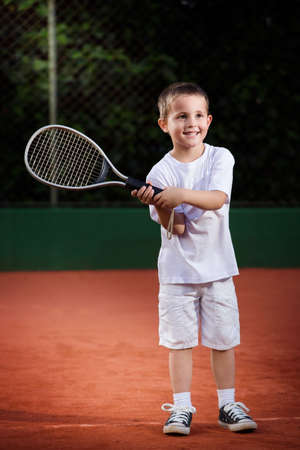 child playing tennisの写真素材