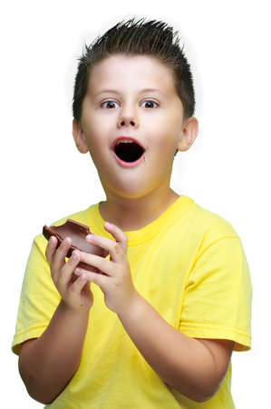 boy eating delicious chocolate eggs, celebrating Easterの写真素材