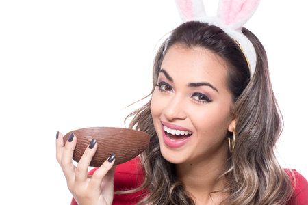 Beautiful young woman holding a chocolate eggの写真素材