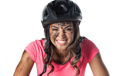 Woman covered in mud when riding a bikeの写真素材
