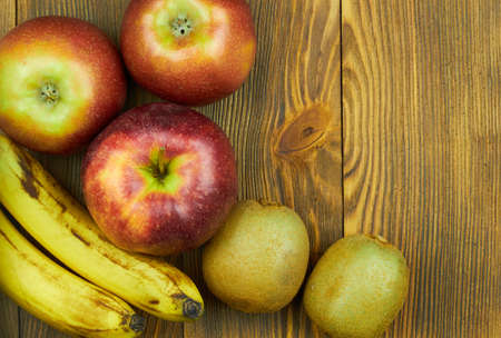 Close up view of red apples and bananas on wooden background with copy space for text. Still life of fresh fruits.の写真素材