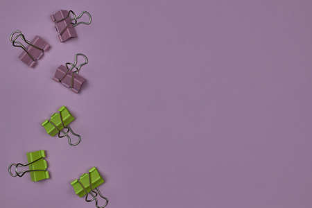 Pink and yellow paper clips on a pink background with copy space for text.の写真素材
