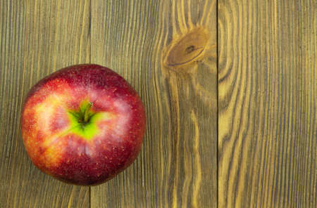 Close up view of red apple on wooden background with copy space for text.の写真素材