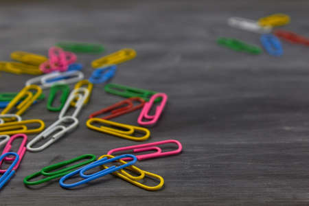 Multicolored paper clips on a dark backgroundの写真素材