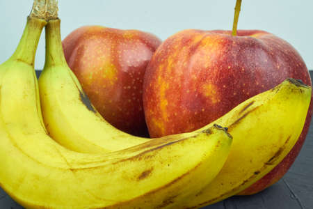 Fresh fruits. Top view of red apple and bananasの写真素材
