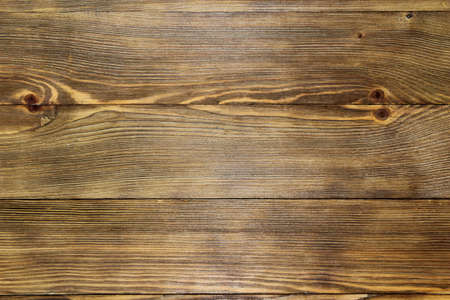 Close up view of bright light brown wooden boards with pronounced wood texture as a backgroundの写真素材