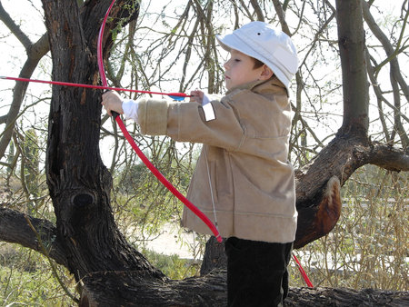 Young boy shooting boy and arrow