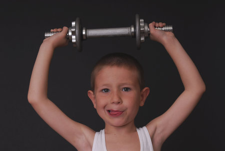 Young boy working out with weights pocket herculesの写真素材