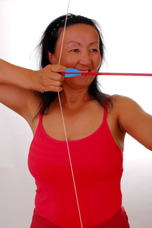 Lovely lady shooting a bow and arrow