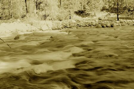 Sepia toned smooth flowing riverの写真素材
