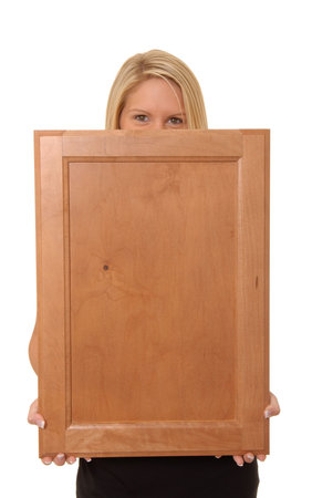 Beautiful and sexy young blond girl isolatedholding a vlank wooden signの写真素材