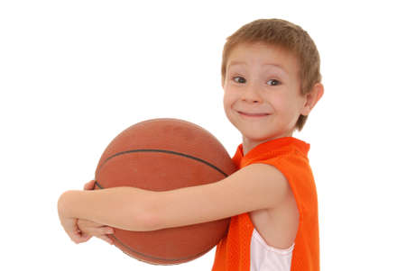 Young boy playing with a basketball isolated on whiteの写真素材