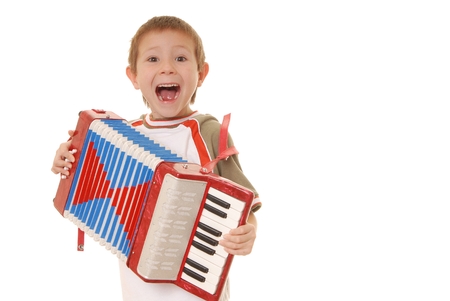 Isolated young boy playing a diatonic accordionの写真素材
