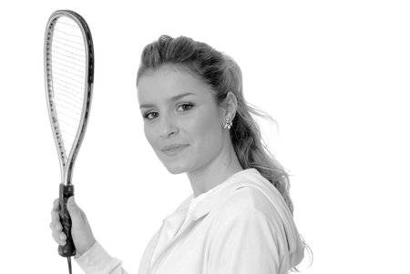 Lovely isolated blond girl with tennis racketの写真素材