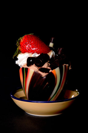 Chocolate and strawberry mouse isolated on blackの写真素材