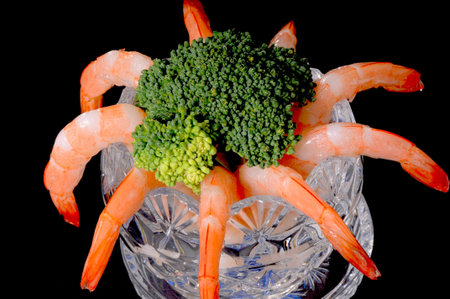 Shrimp cocktail with brocolli isolated over blackの写真素材