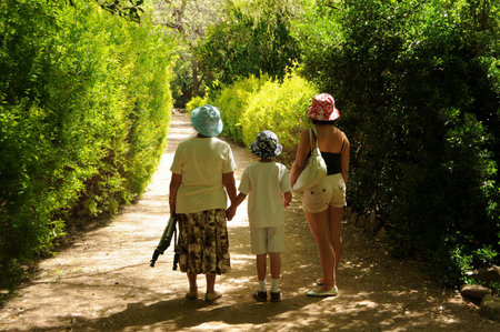 Boy mother and grandmother hiking along a trailの写真素材