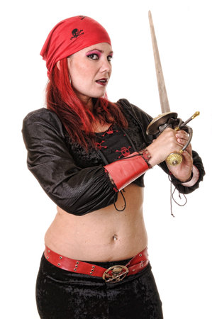 Isolated lovely and sexy young dancing girl holding a swordの写真素材