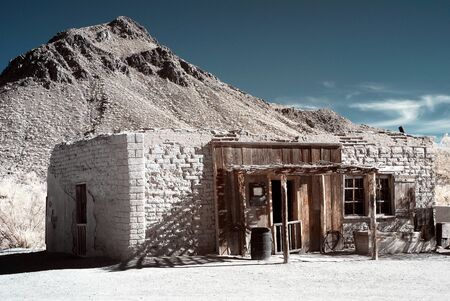 Old style western adobe building mountain backgroundの写真素材