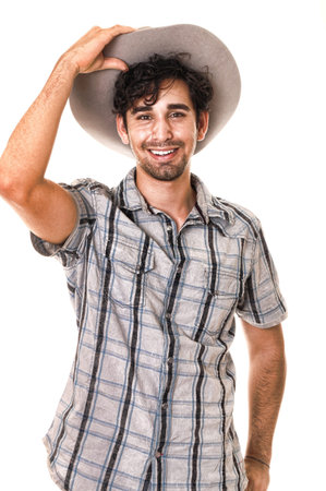 Young boy wearing a cowboy hat isolated on whiteの写真素材